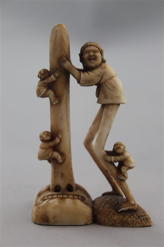 A Japanese ivory netsuke of Ashinaga holding the nose of a Tengu mask, Edo period, 6.9cm